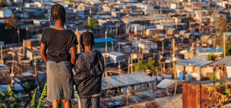 Environmental justice - children observe poor community from above. Photo: Getty Images