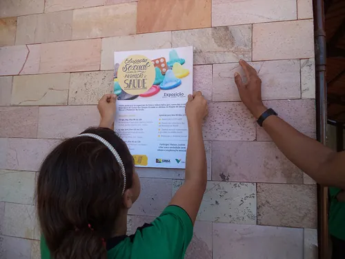 Child hangs material about sex education on wall Child hangs material about sex education on wall