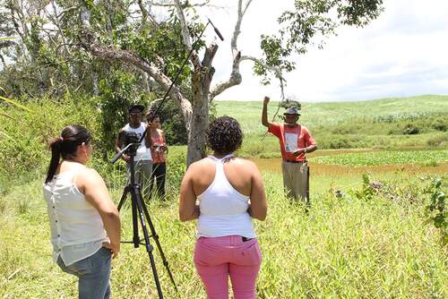 Resident poses for photographic record and ethnocultural rescue