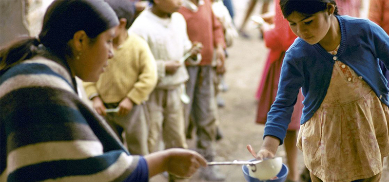 Social justice: people sharing food. Photo: UN News
