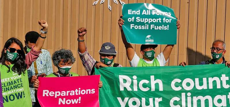 Synergia at COP_ Activists-display-placards-demanding-rich-countries-to-help-poor-nations-combat-climate-changes-during-COP-27,-in-Sharm-El- Sheikh-in-Egypt-on-November-9-2022.-Photo-Thaier-Al-Sudani_Reuters