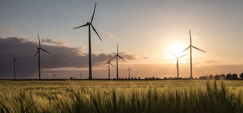 importance of climate justice. Wind power plants. Photo: Adobe Stock