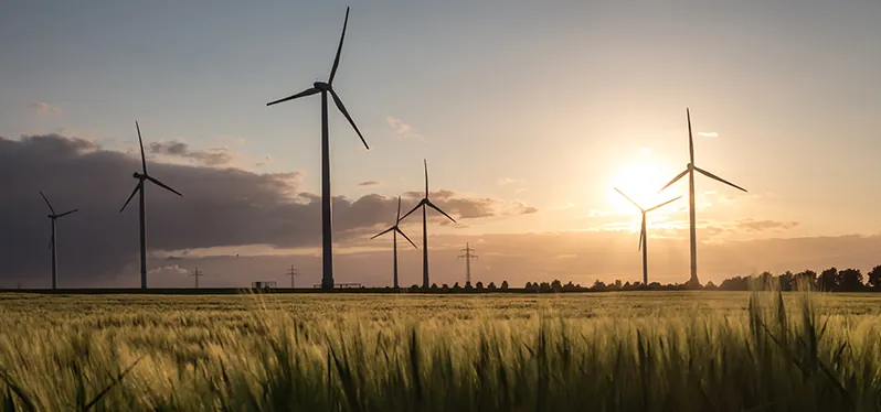 importance of climate justice. Wind power plants. Photo: Adobe Stock